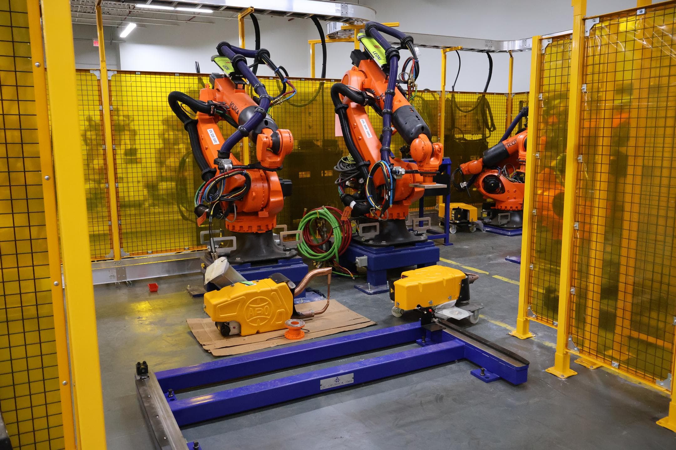 Robots, custom tooling, and engineering work inside the Ethos facility